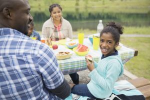 Family eating at picnic table