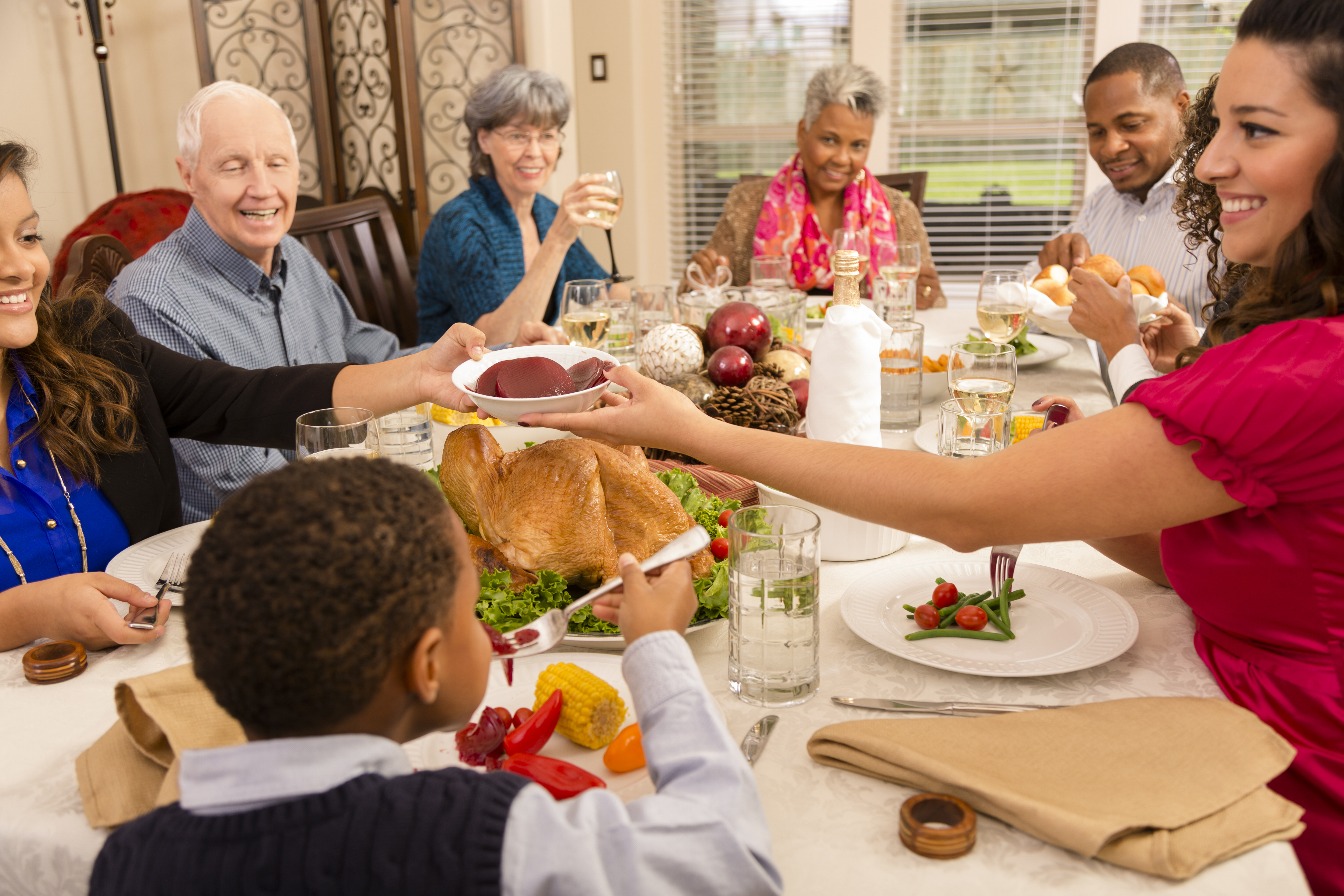 Holidays: Family, friends gather for dinner at senior woman's home.