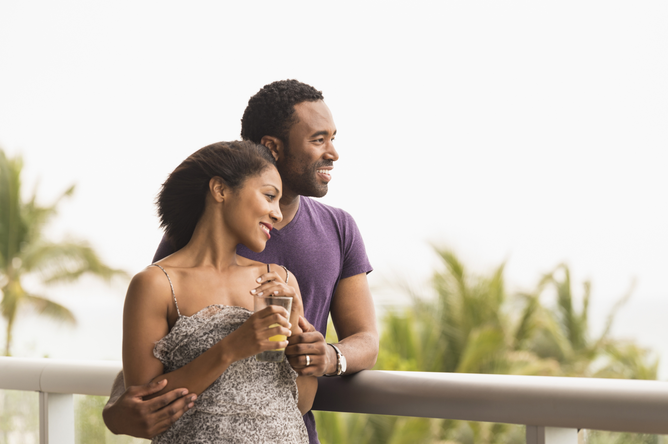 Couple admiring scenic view from balcony