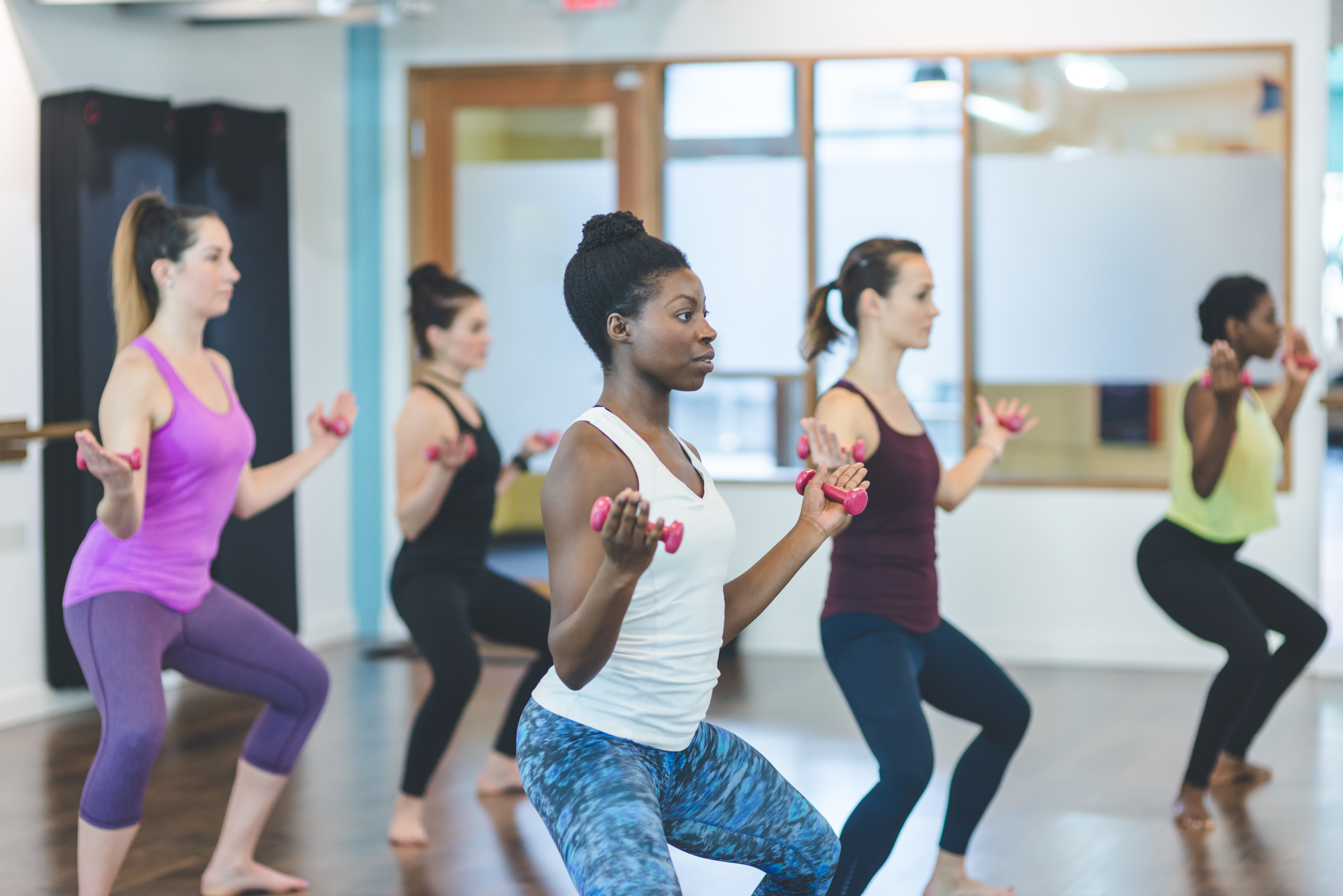 Group of Women Doing Barre + TRX Workout