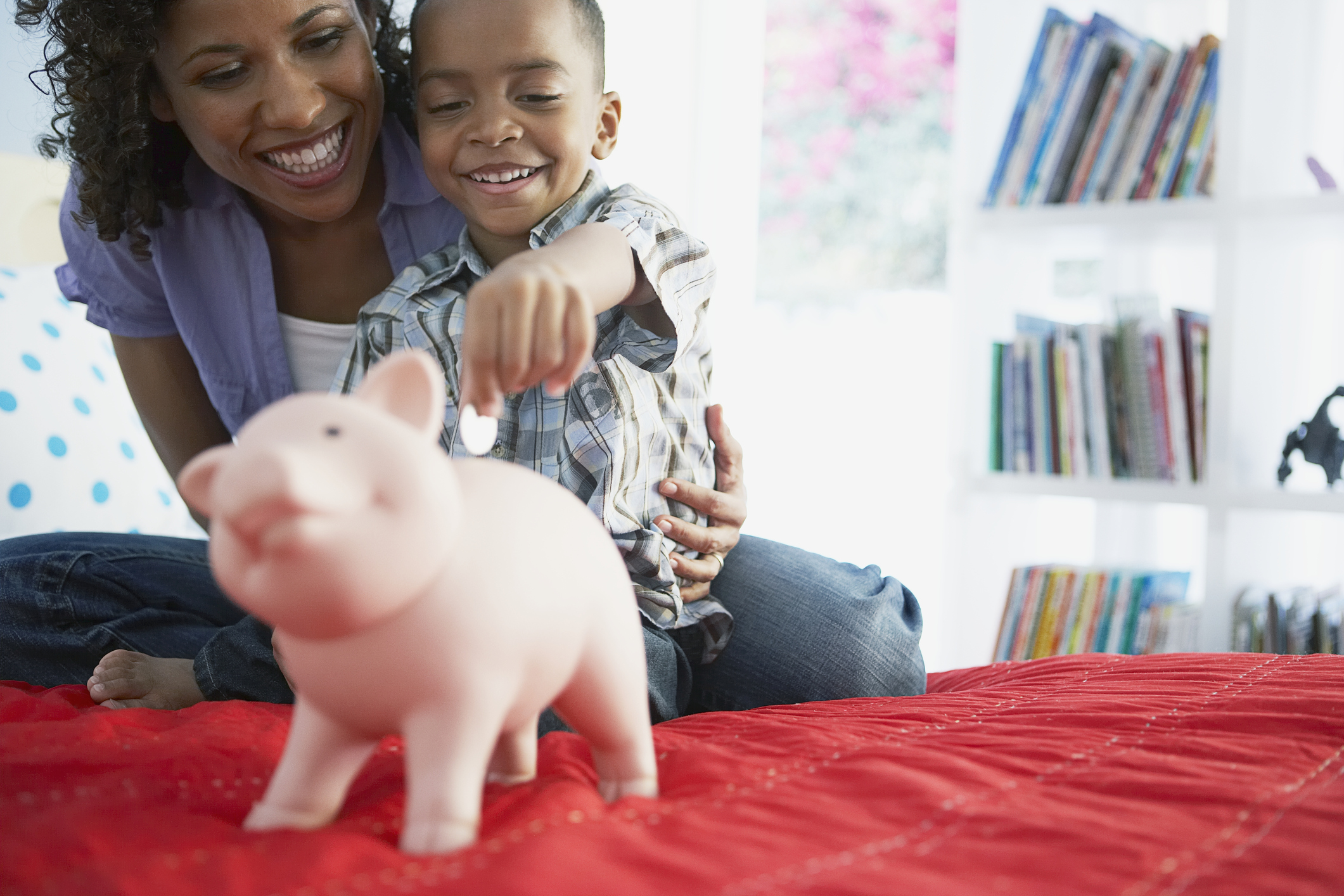 Boy Putting Coin in Bank