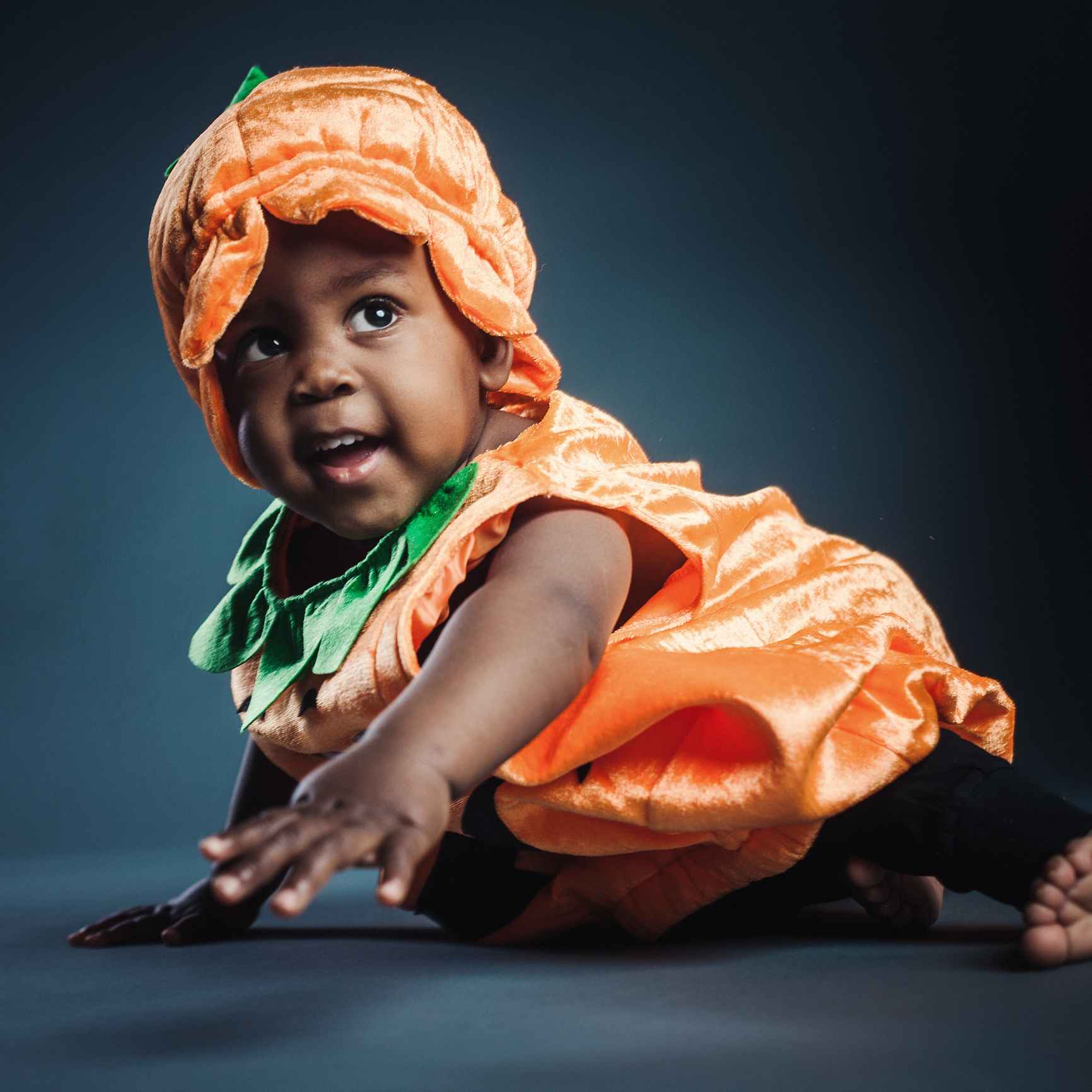 Cute baby boy in pumpkin costume