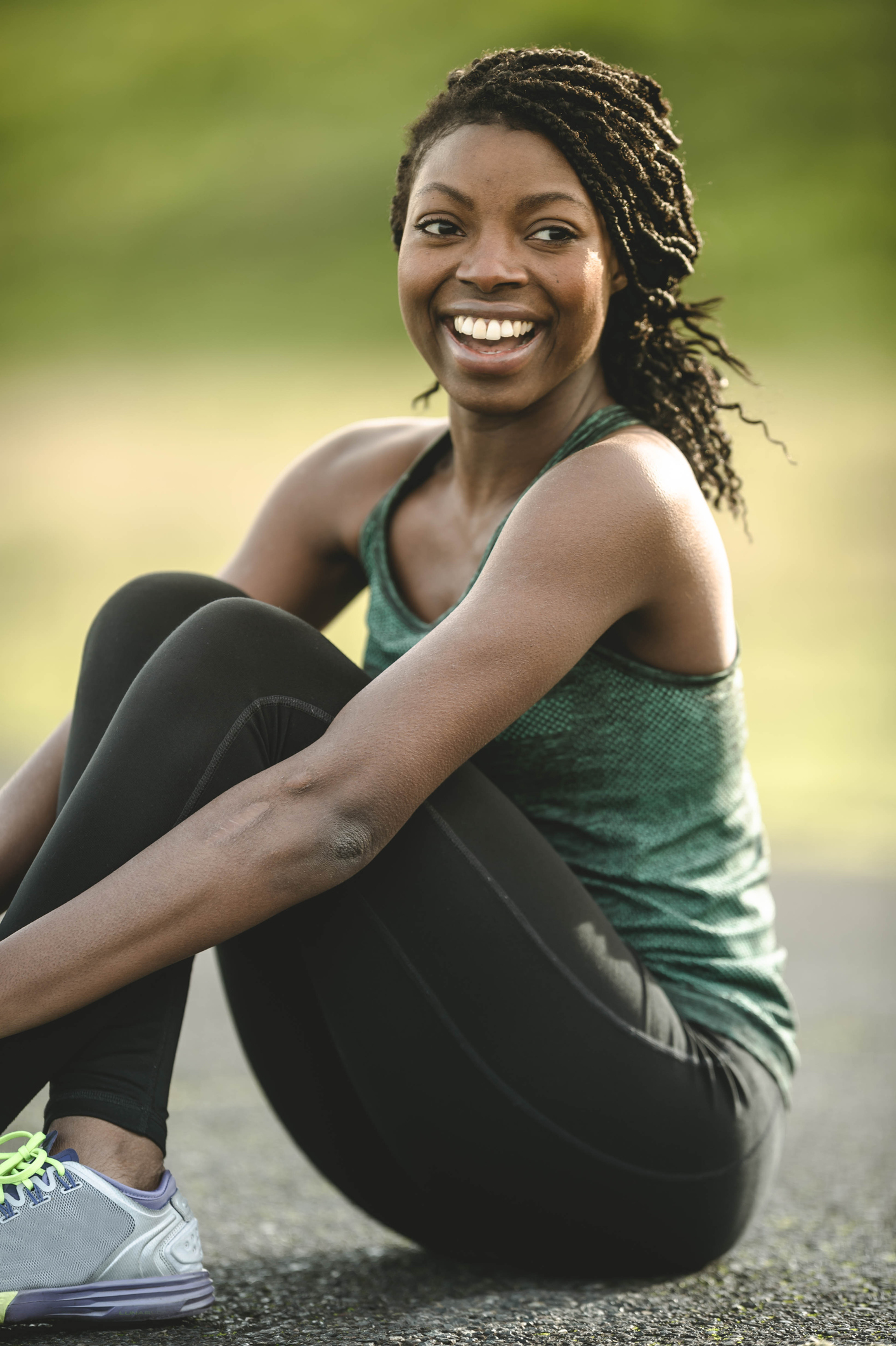 African American woman doing yoga outside by river