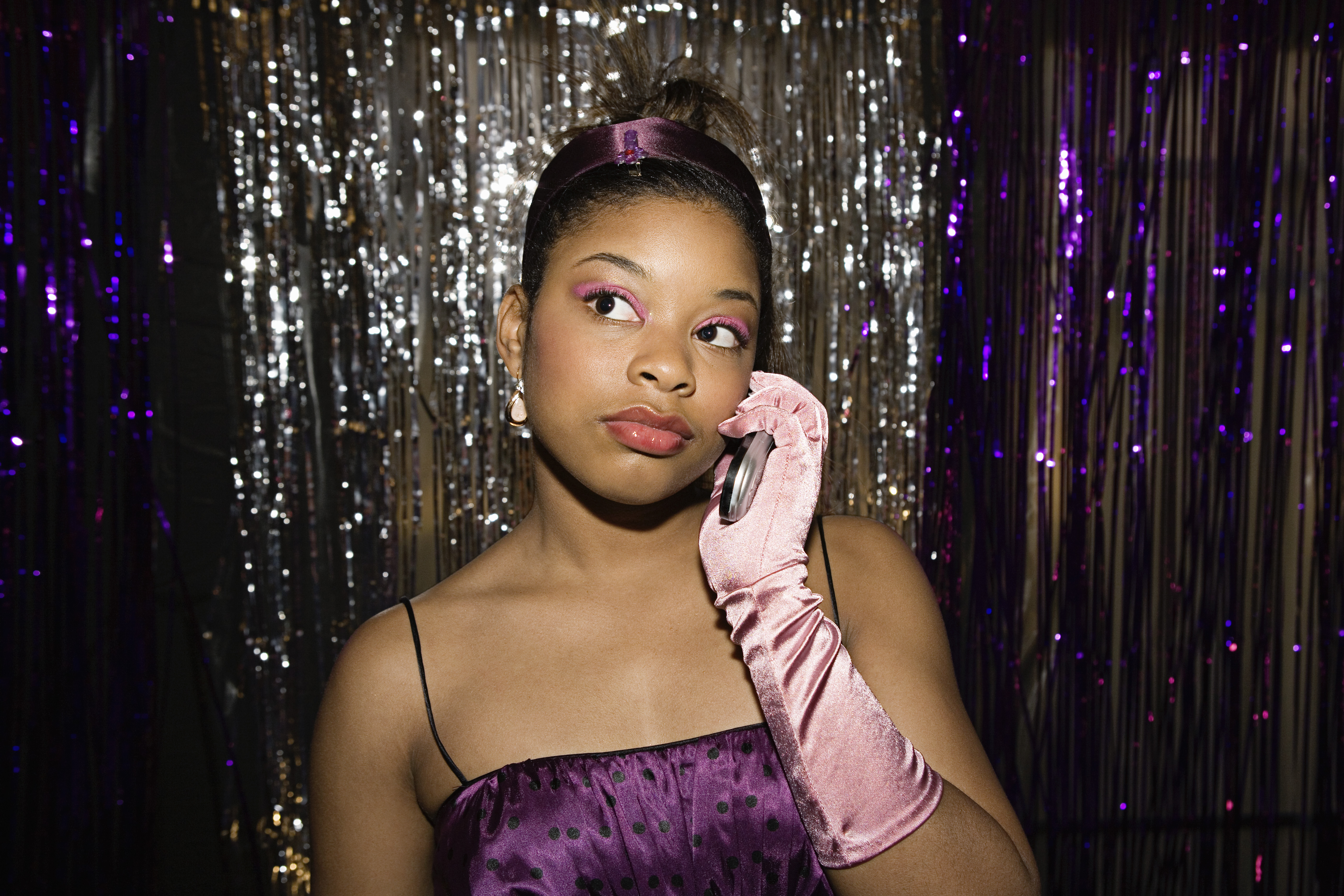 Teenage girl talking on cell phone at prom