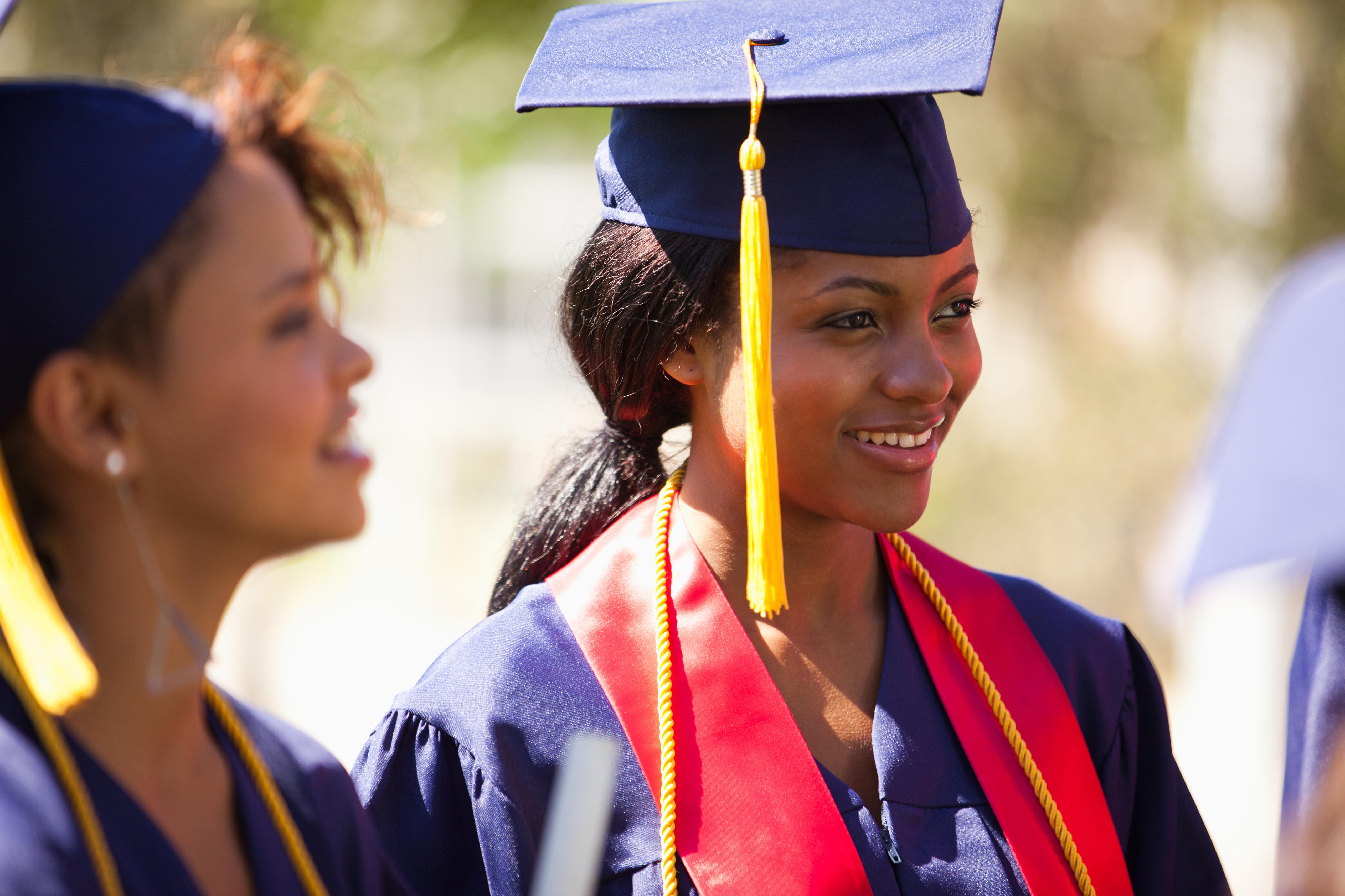 Graduates smiling in cap and gown