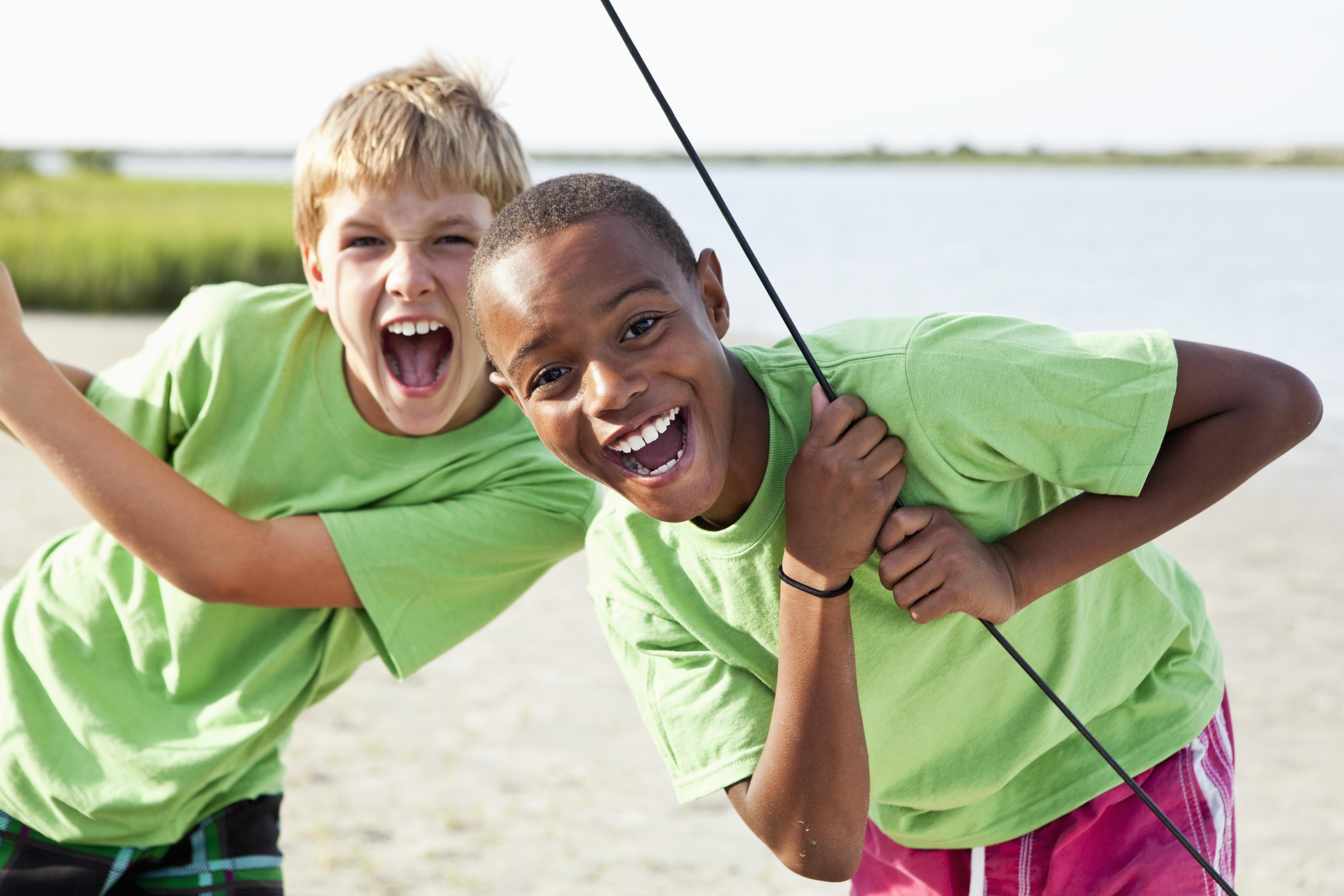 Boys standing on catamaran