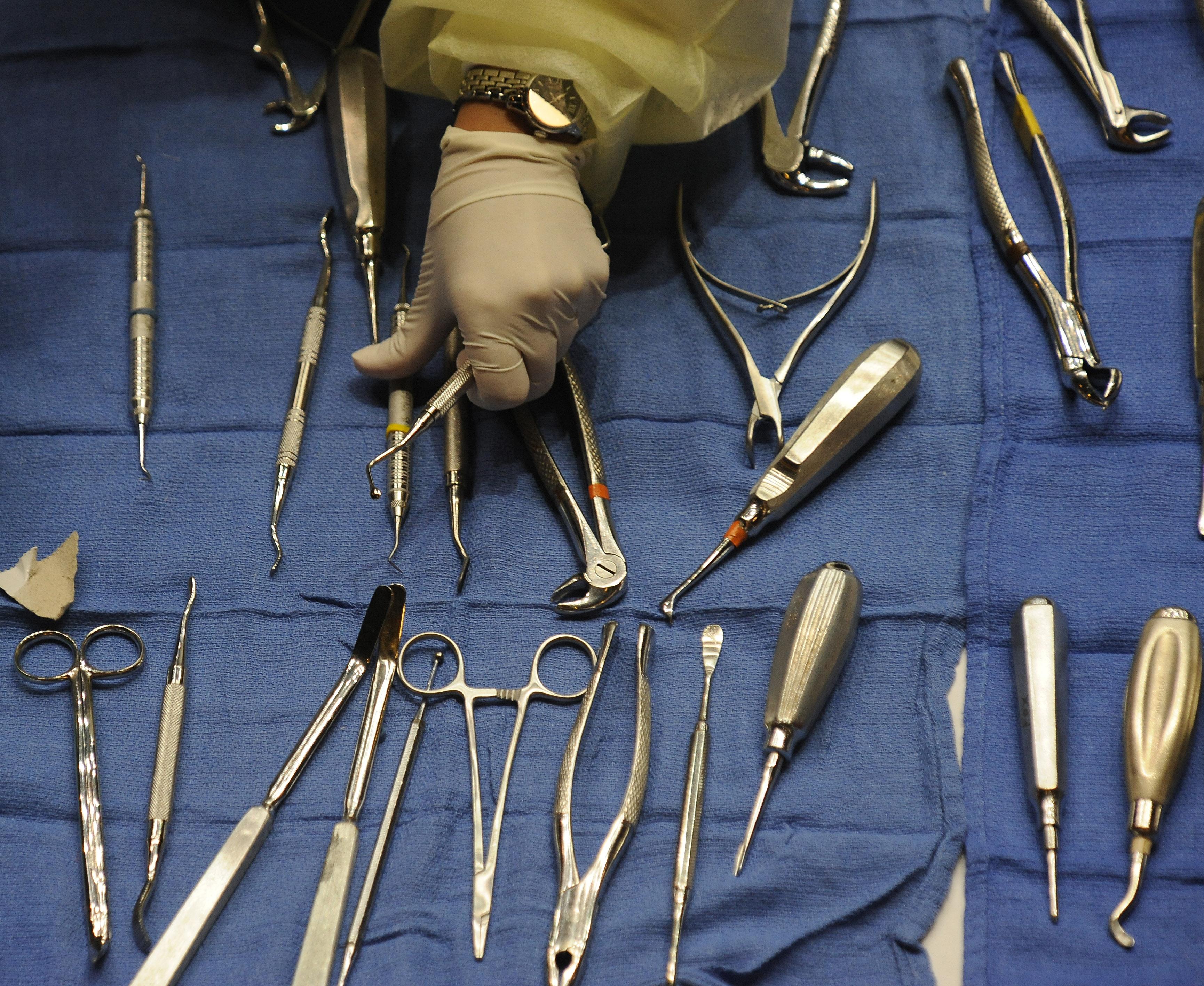 A volunteers gets dental tools for denti