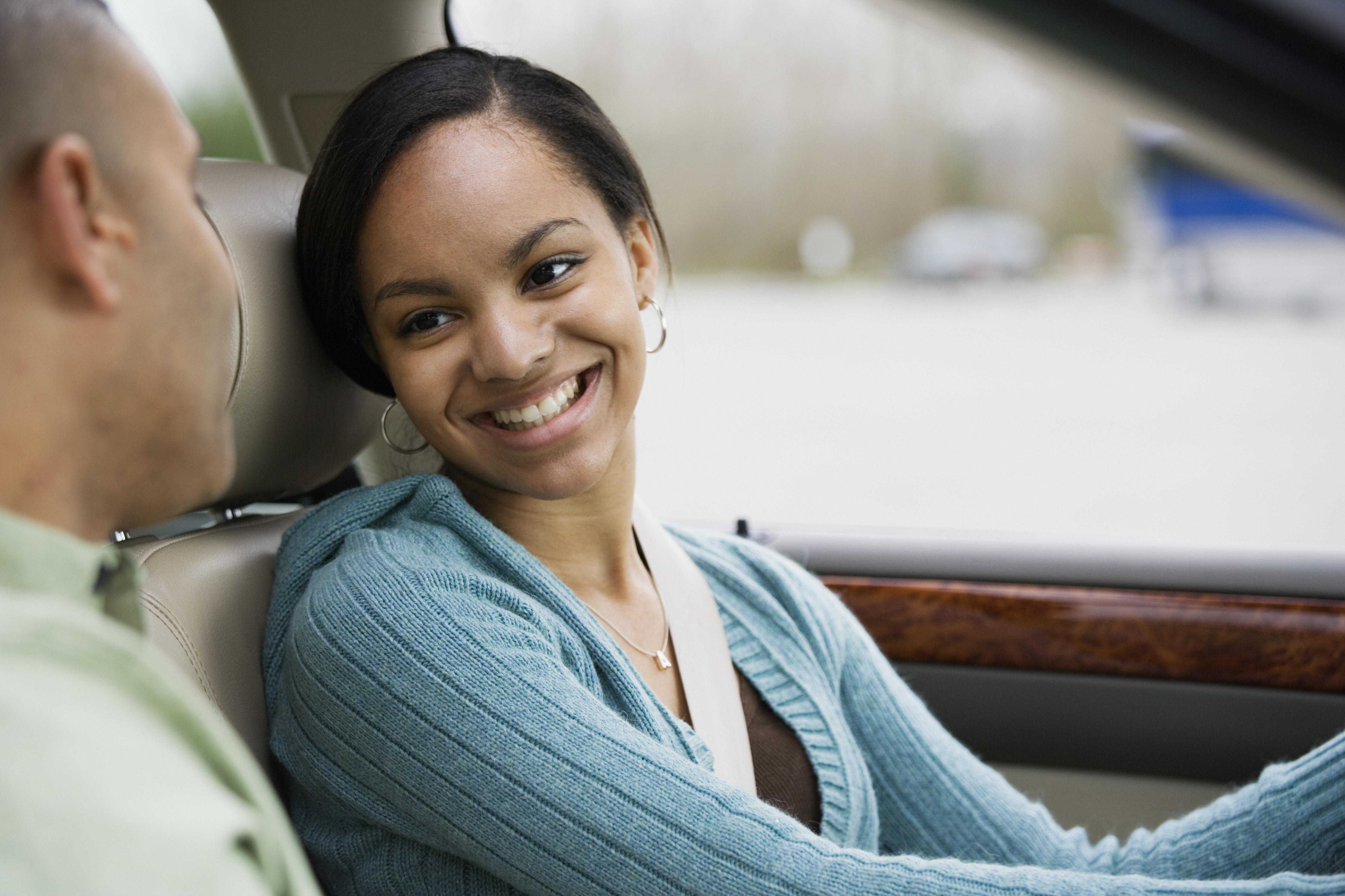 African teenager in car with father