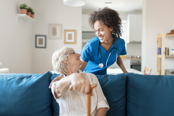 Portrait of Smiling Senior Woman and Her Mixed Race Female Caregiver