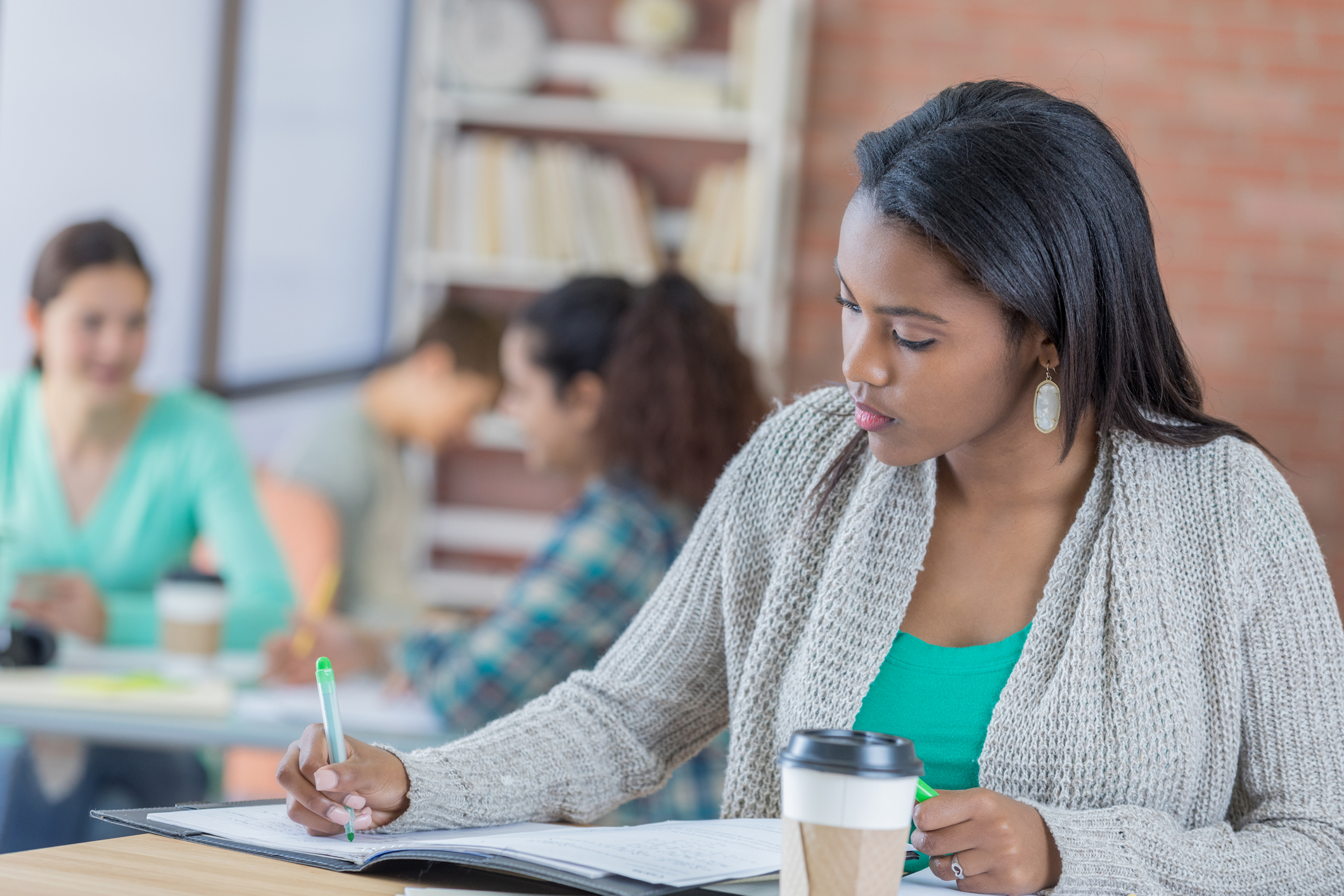 College student concentrates while studying in the student center