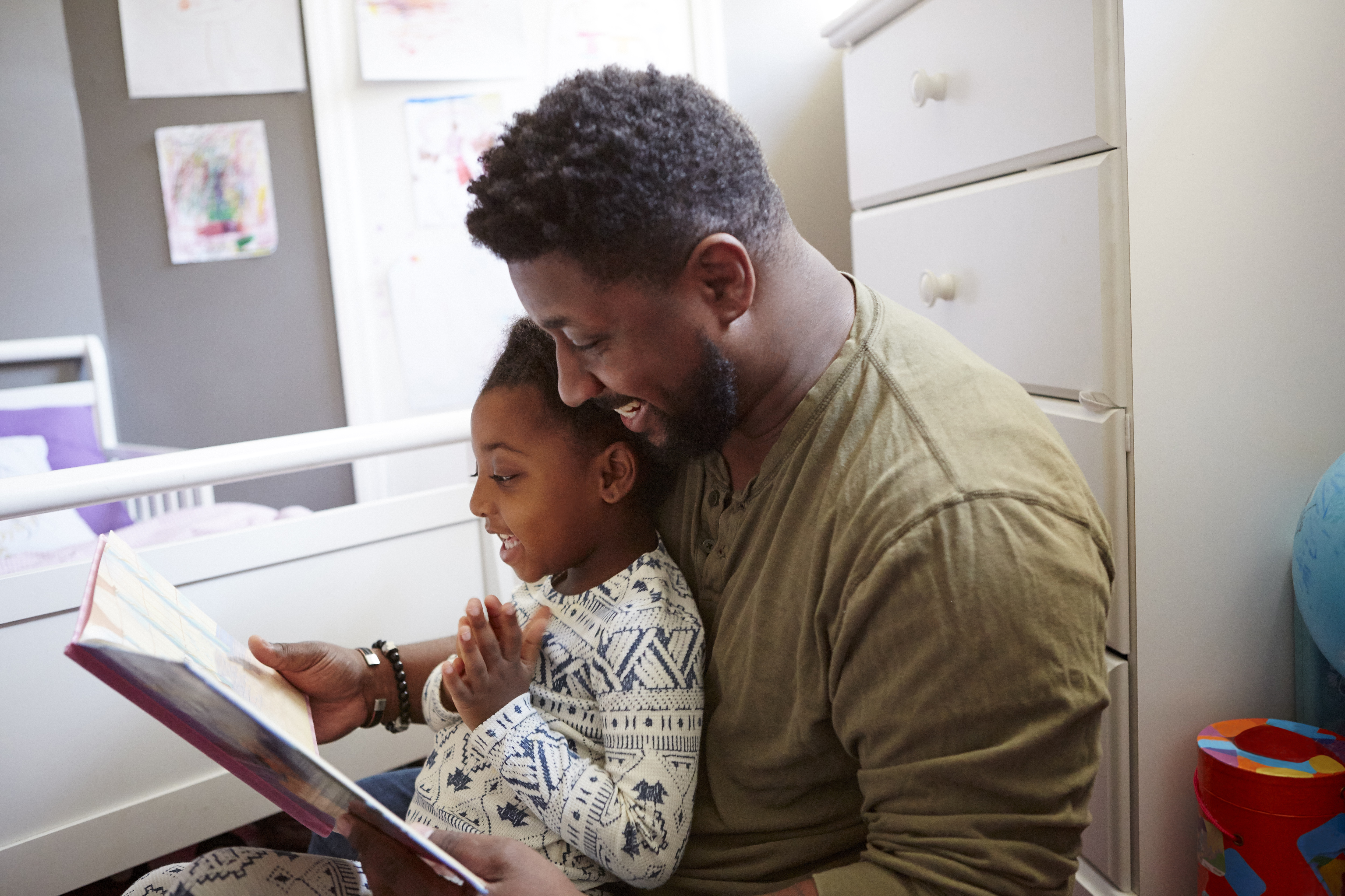 Father reading to daughter