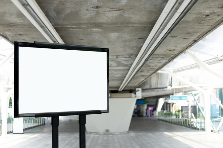 Blank white banner at metro station. Blank billboard in railway station, mock up.