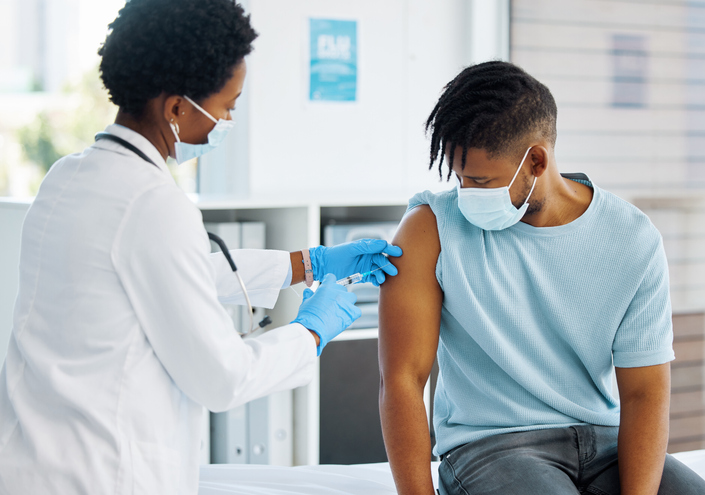 Shot of a doctor giving her patient an injection