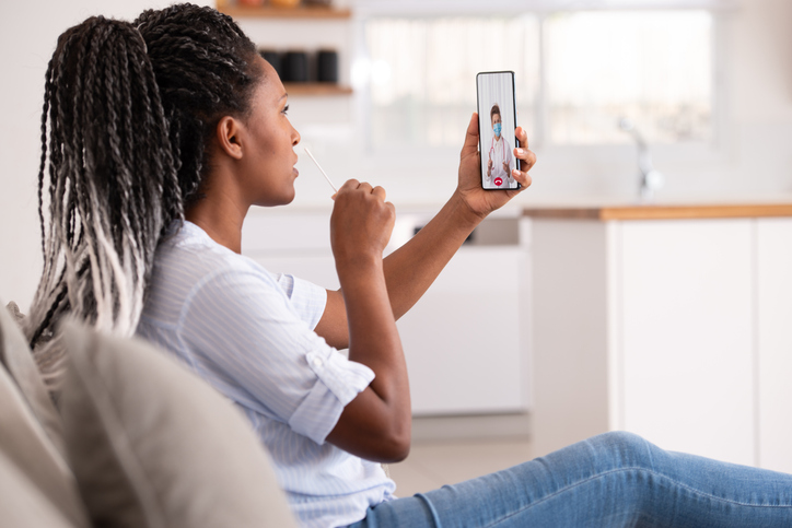 Woman collecting a nasal sample for Coronavirus test.