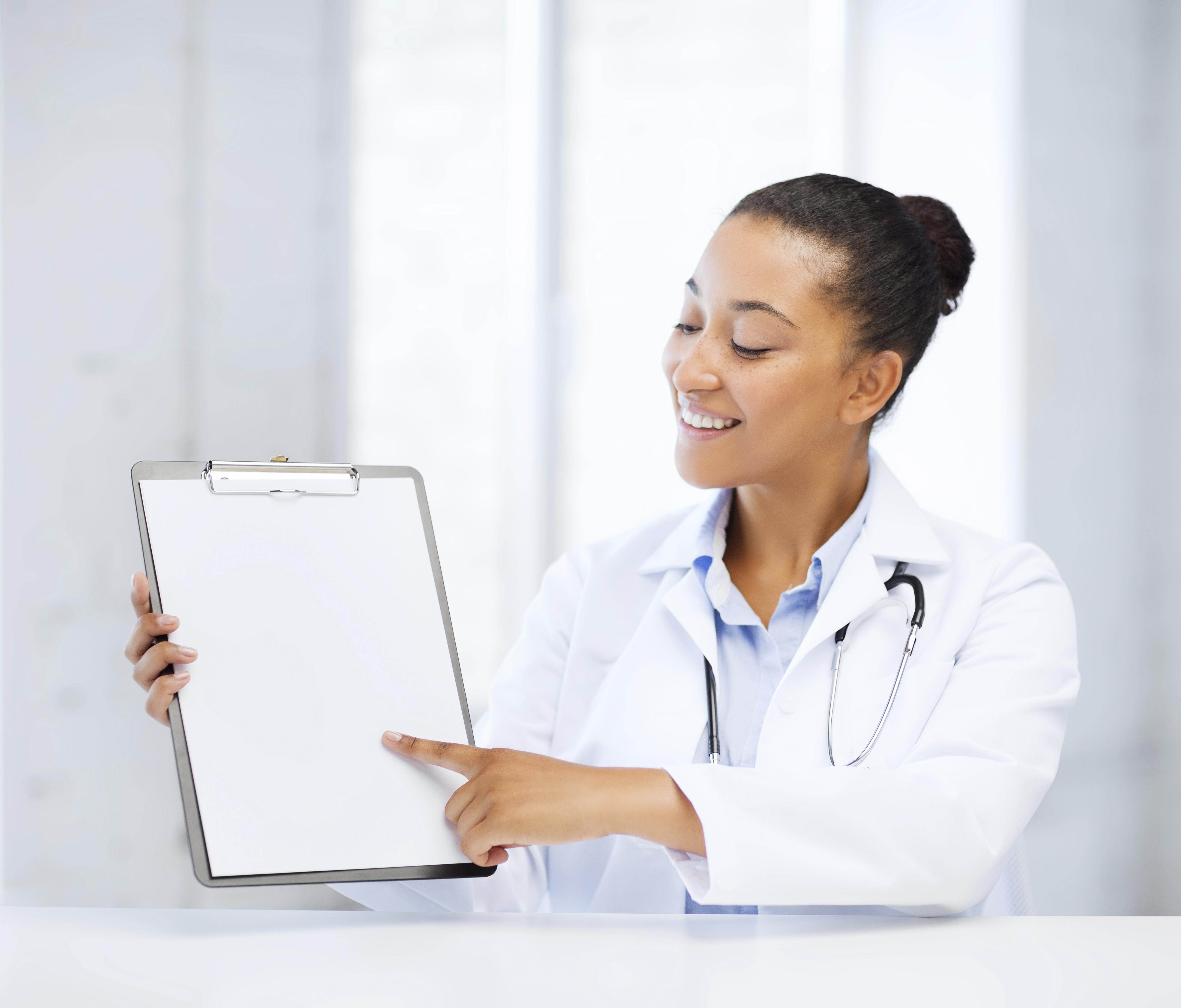 health care and medical concept - female doctor with stethoscope and blank prescription