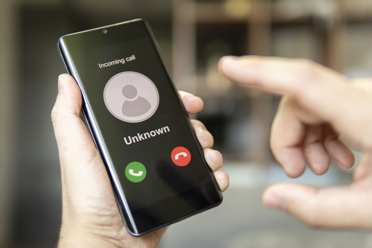 Phone call from unknown number. Scam, fraud or phishing with smartphone concept. Prank caller, scammer or stranger. Man answering to incoming call. Hoax person with fake identity.