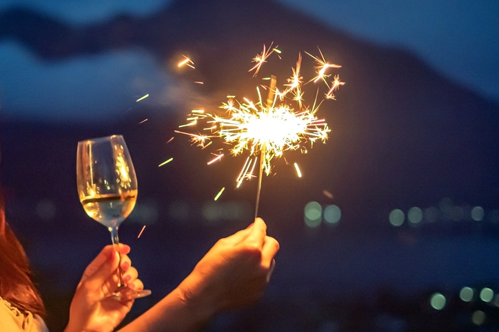 Female Hands Holding a Burning Sparklers on New Year’s Eve