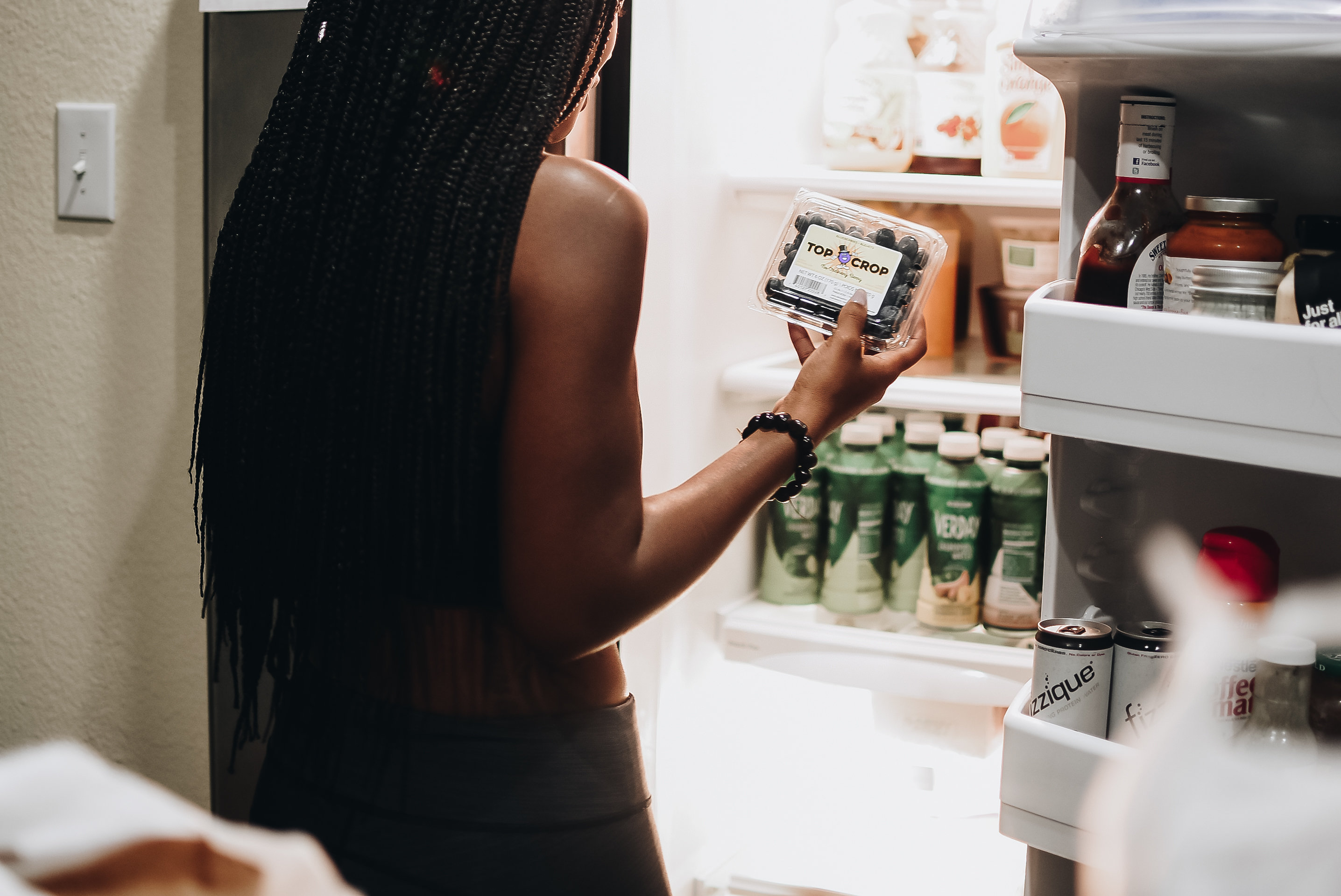 Woman looking Inside Refrigerator