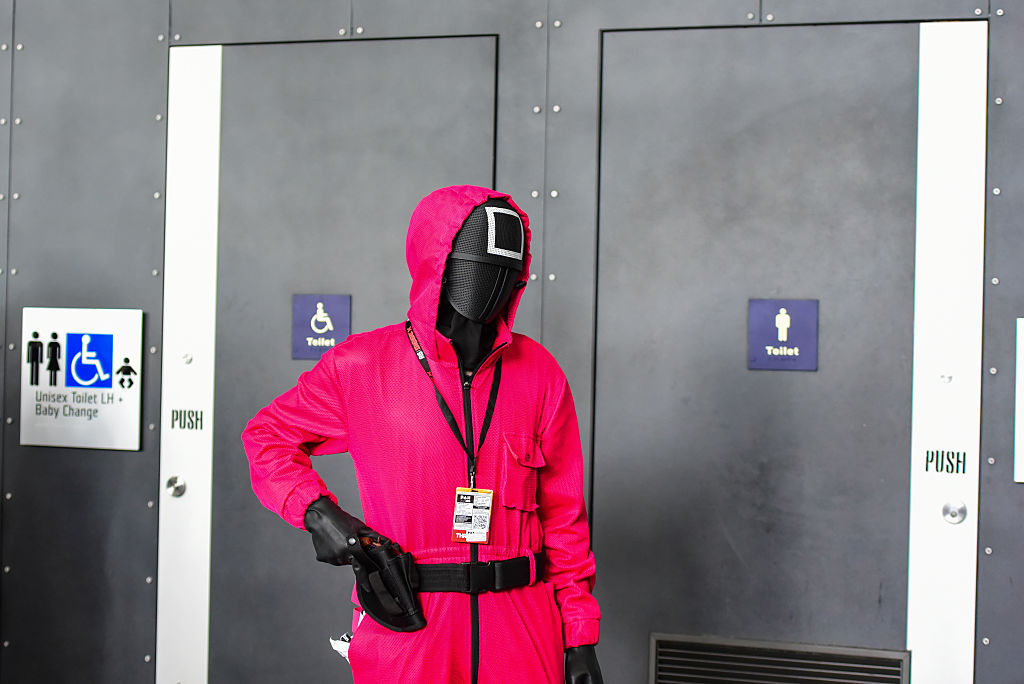 Cosplayer wearing Pink Guard costume from Squid Game is seen...